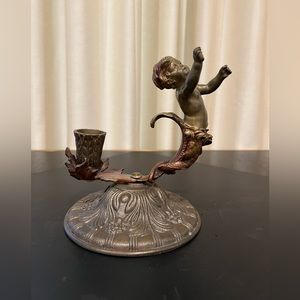 Candle holder with beautiful cherub statue.